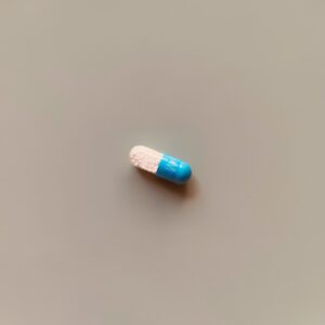 a blue and white pill sitting on top of a table