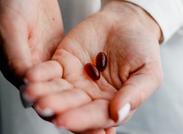 person holding brown and black round ornament